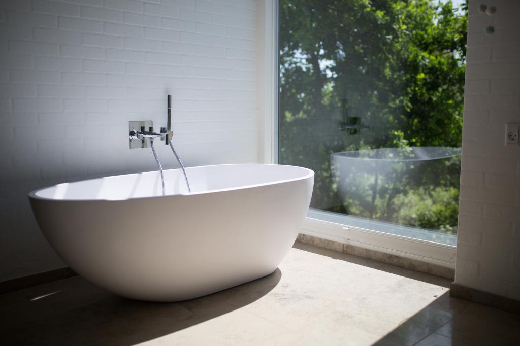 a free standing bath tub in front of a window